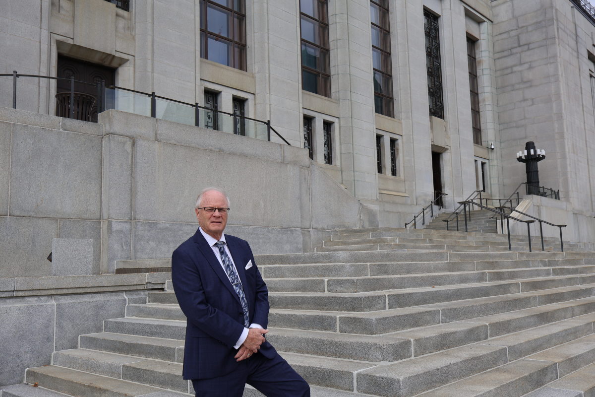 Daniel Gordon Pole in front of a court house.